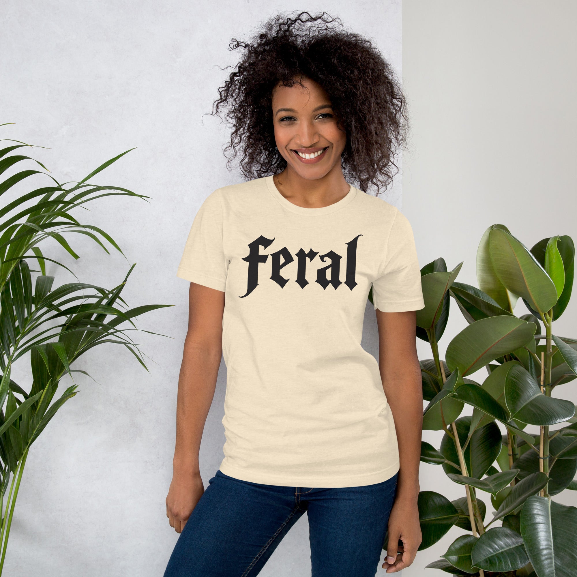Feral in white blackletter font on dark heather grey t-shirt, bold single word graphic design, Artificial Perdition apparel