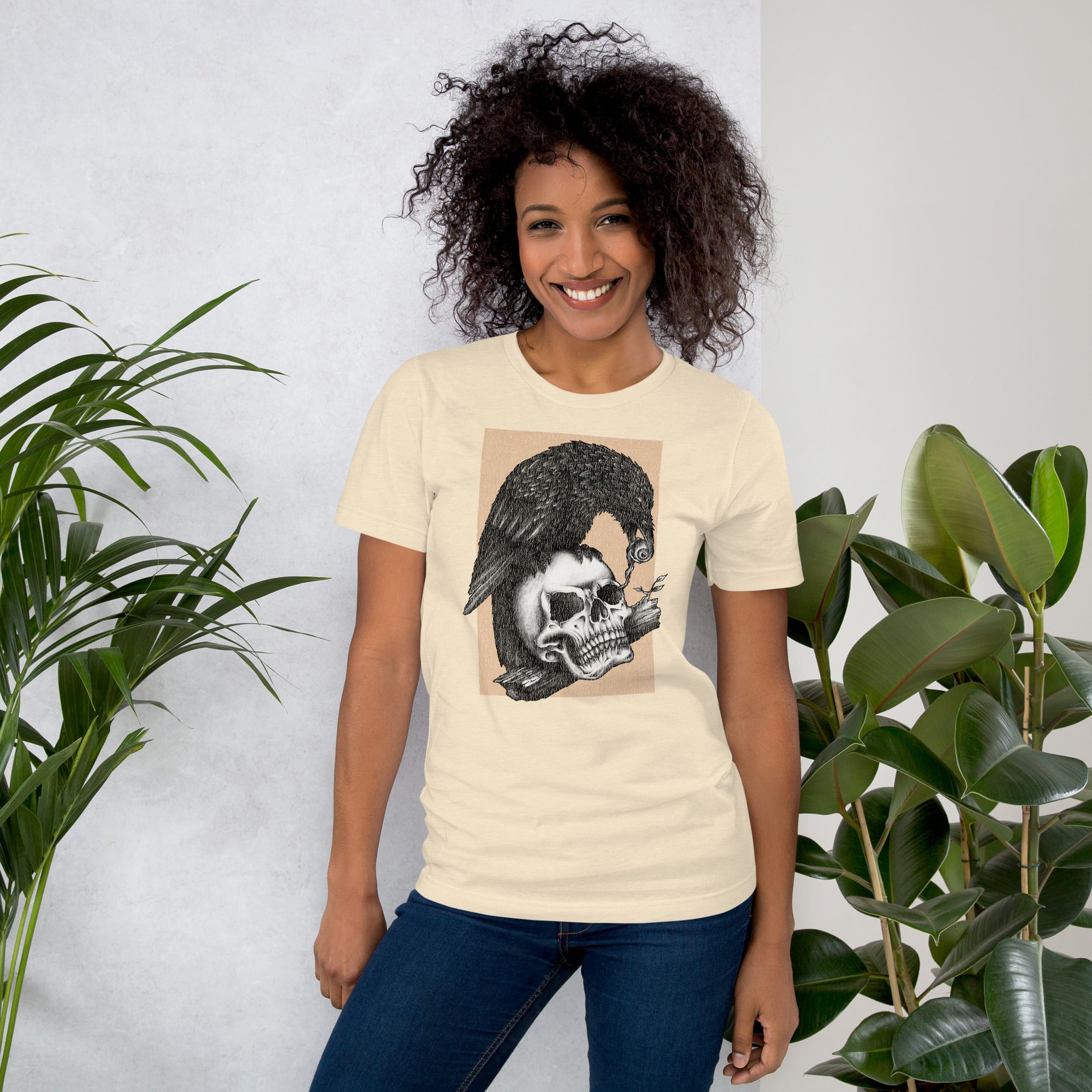 Graphite illustration of a black corvid perched on a human skull removing the eye, sprouting branch beside it, Last Look, Artificial Perdition apparel