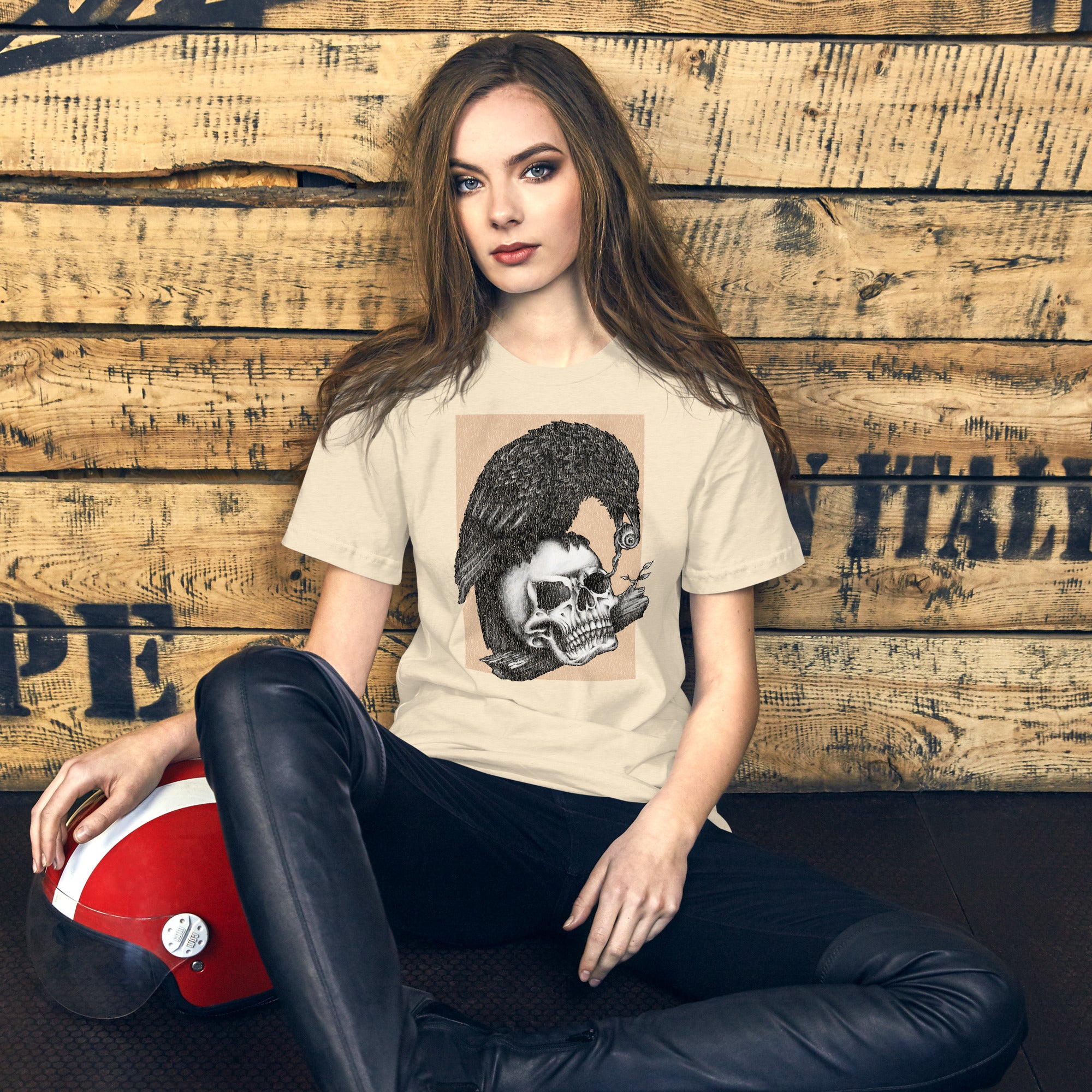 Graphite illustration of a black corvid perched on a human skull removing the eye, sprouting branch beside it, Last Look, Artificial Perdition apparel