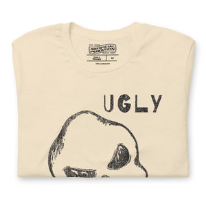 Crude hand-drawn skull with mismatched eye sockets and UGLY text in the upper corner, anti-polish graphic design, Artificial Perdition apparel