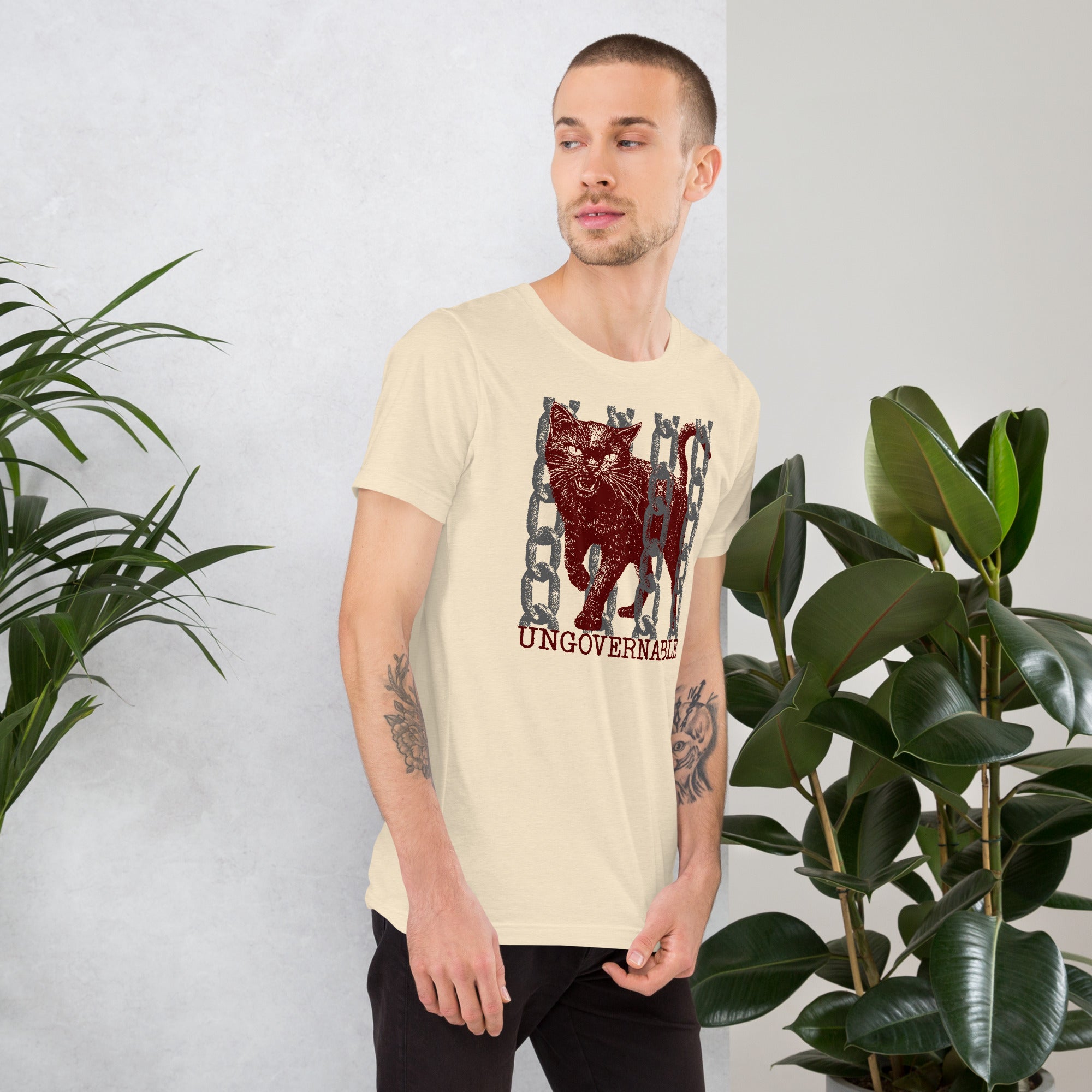 Product mockupSnarling cat breaking through chains with UNGOVERNABLE text, dithered halftone red on cream, Artificial Perdition apparel