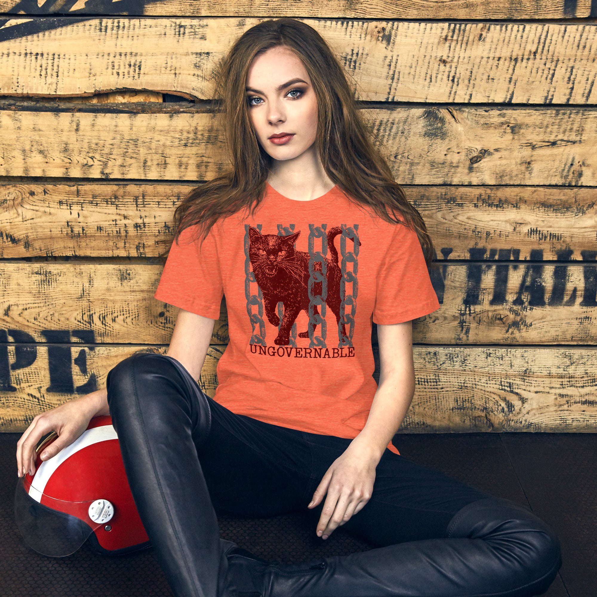 Product mockupSnarling cat breaking through chains with UNGOVERNABLE text, dithered halftone red on cream, Artificial Perdition apparel