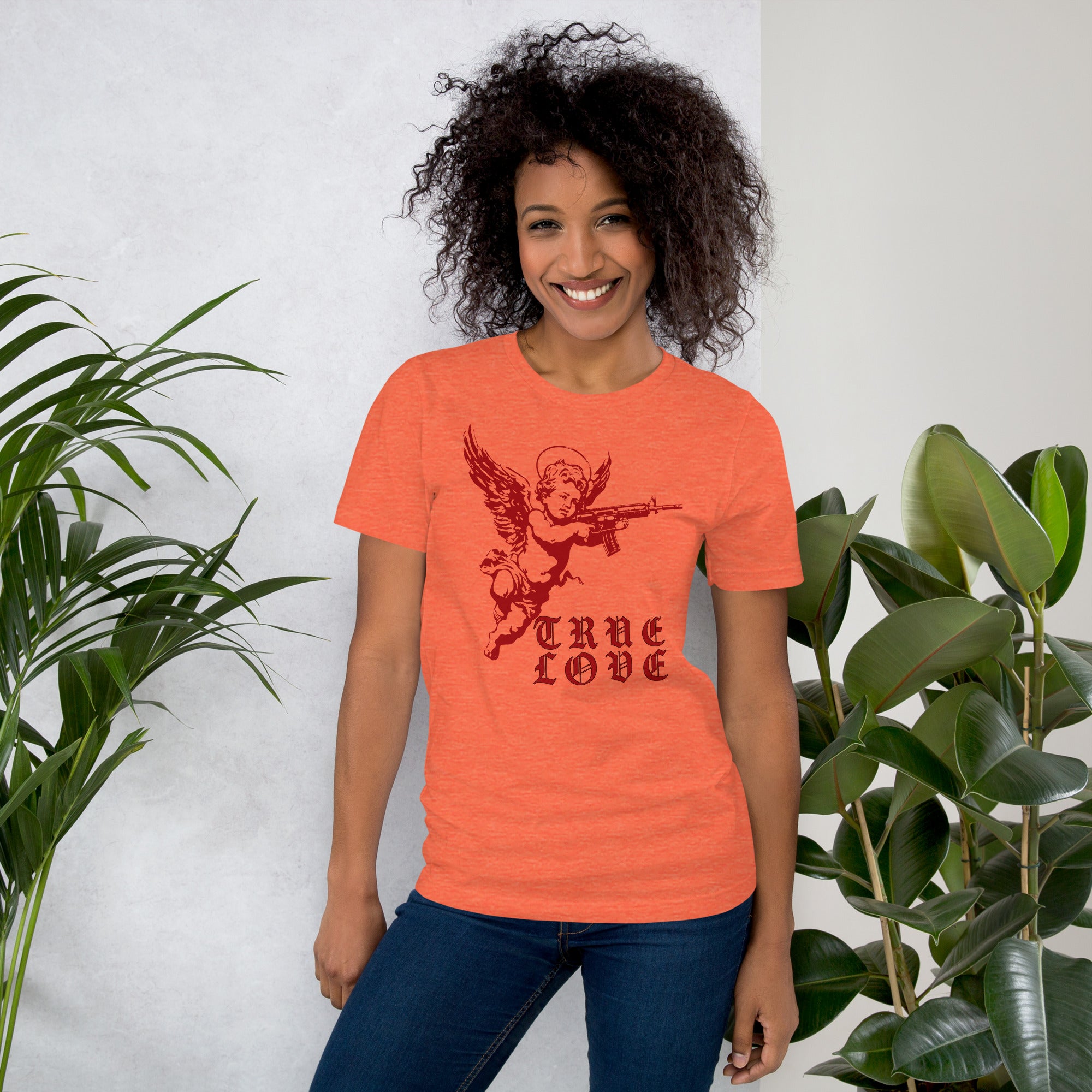 Red cherub angel with halo aiming rifle above blackletter True Love text, dark ironic tattoo flash style, Artificial Perdition apparel