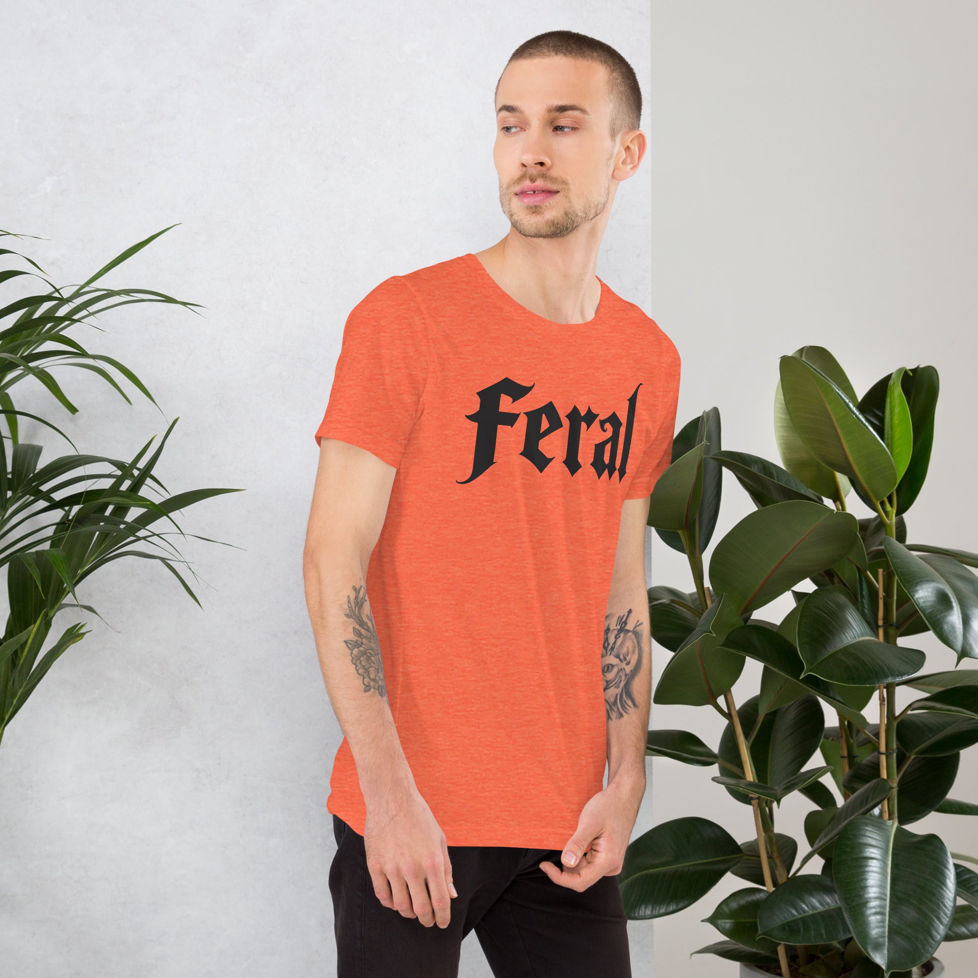 Feral in white blackletter font on dark heather grey t-shirt, bold single word graphic design, Artificial Perdition apparel