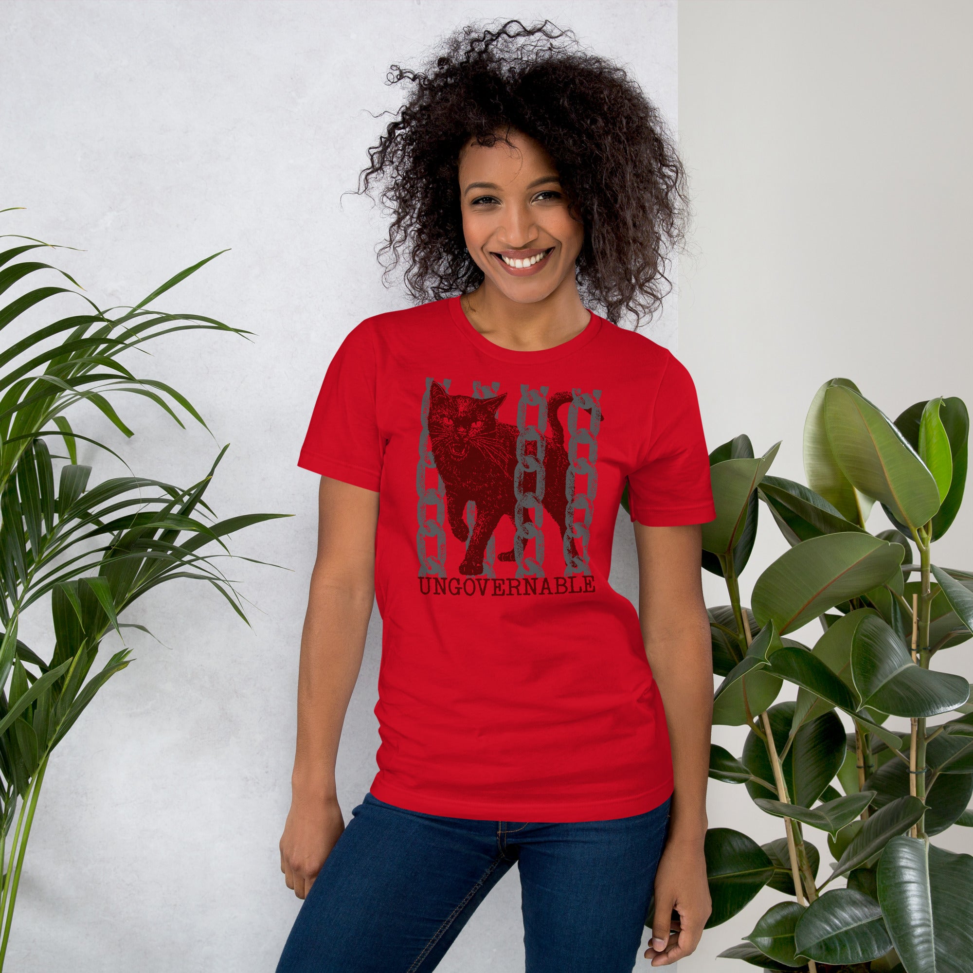 Product mockupSnarling cat breaking through chains with UNGOVERNABLE text, dithered halftone red on cream, Artificial Perdition apparel