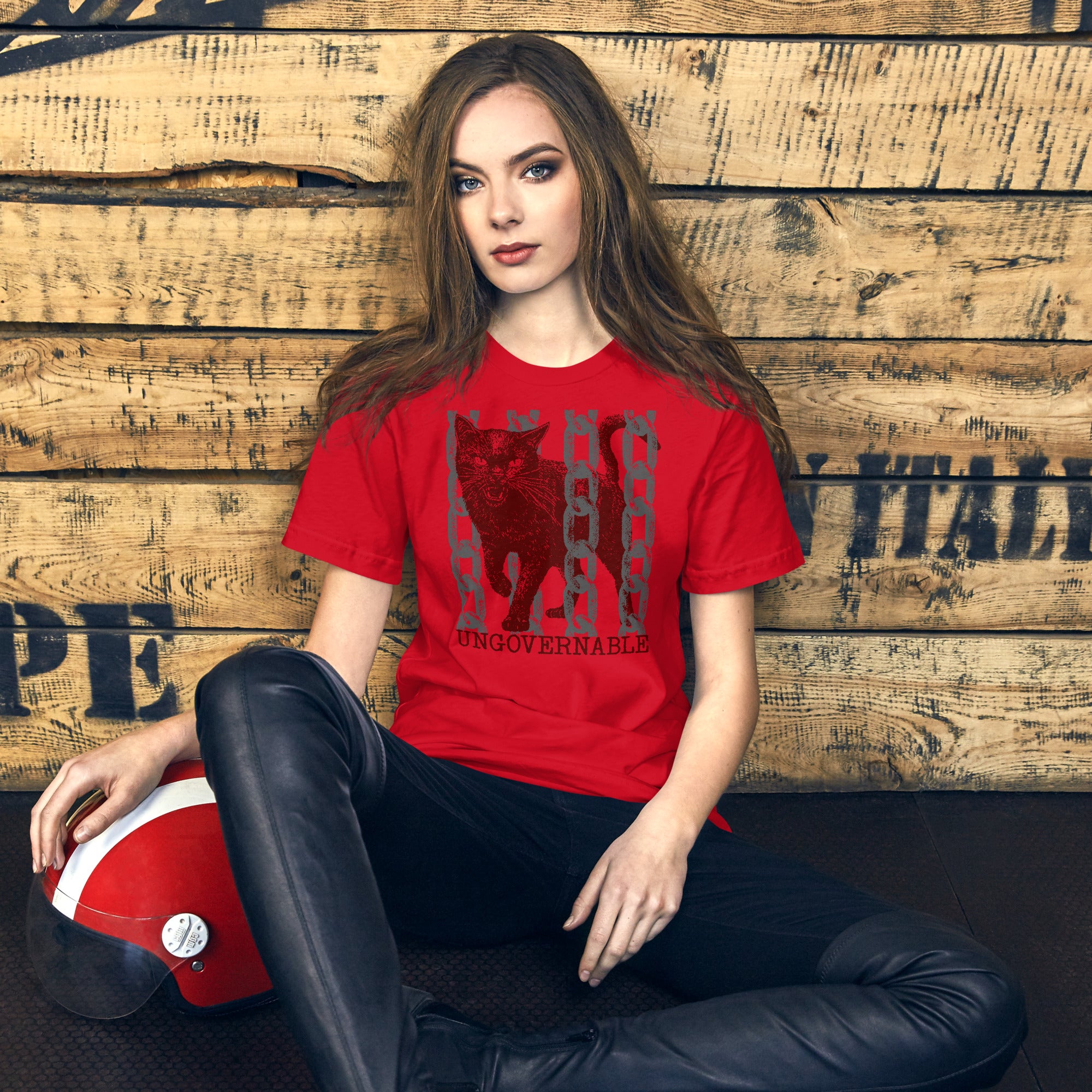 Product mockupSnarling cat breaking through chains with UNGOVERNABLE text, dithered halftone red on cream, Artificial Perdition apparel