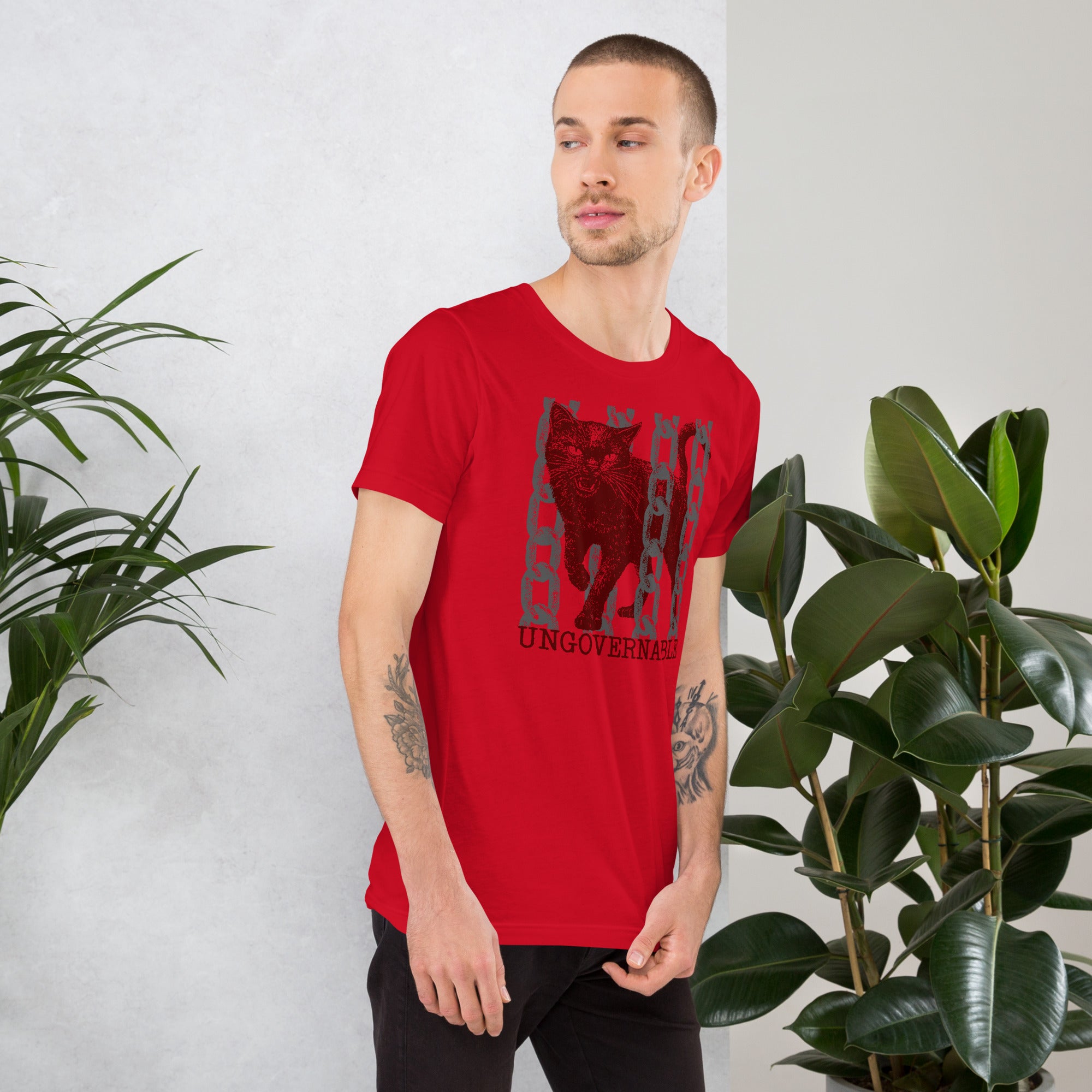 Product mockupSnarling cat breaking through chains with UNGOVERNABLE text, dithered halftone red on cream, Artificial Perdition apparel
