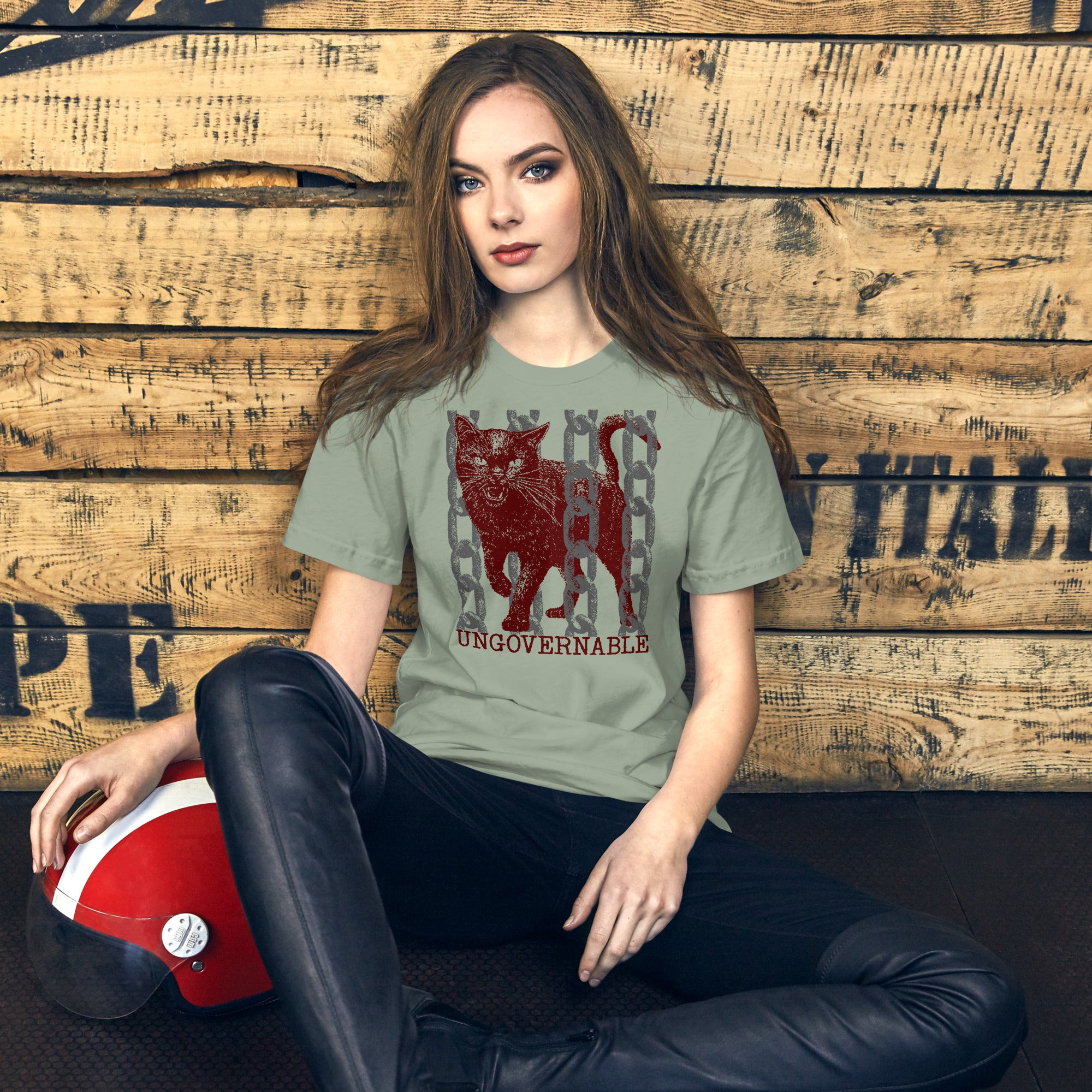 Product mockupSnarling cat breaking through chains with UNGOVERNABLE text, dithered halftone red on cream, Artificial Perdition apparel