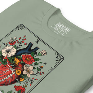 Tarot card illustration numbered X with an anatomical heart in bloom surrounded by wildflowers and vines, Amor Fati, Artificial Perdition apparel