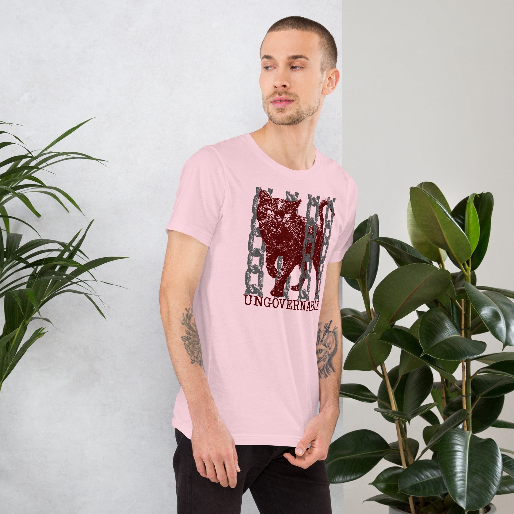 Product mockupSnarling cat breaking through chains with UNGOVERNABLE text, dithered halftone red on cream, Artificial Perdition apparel