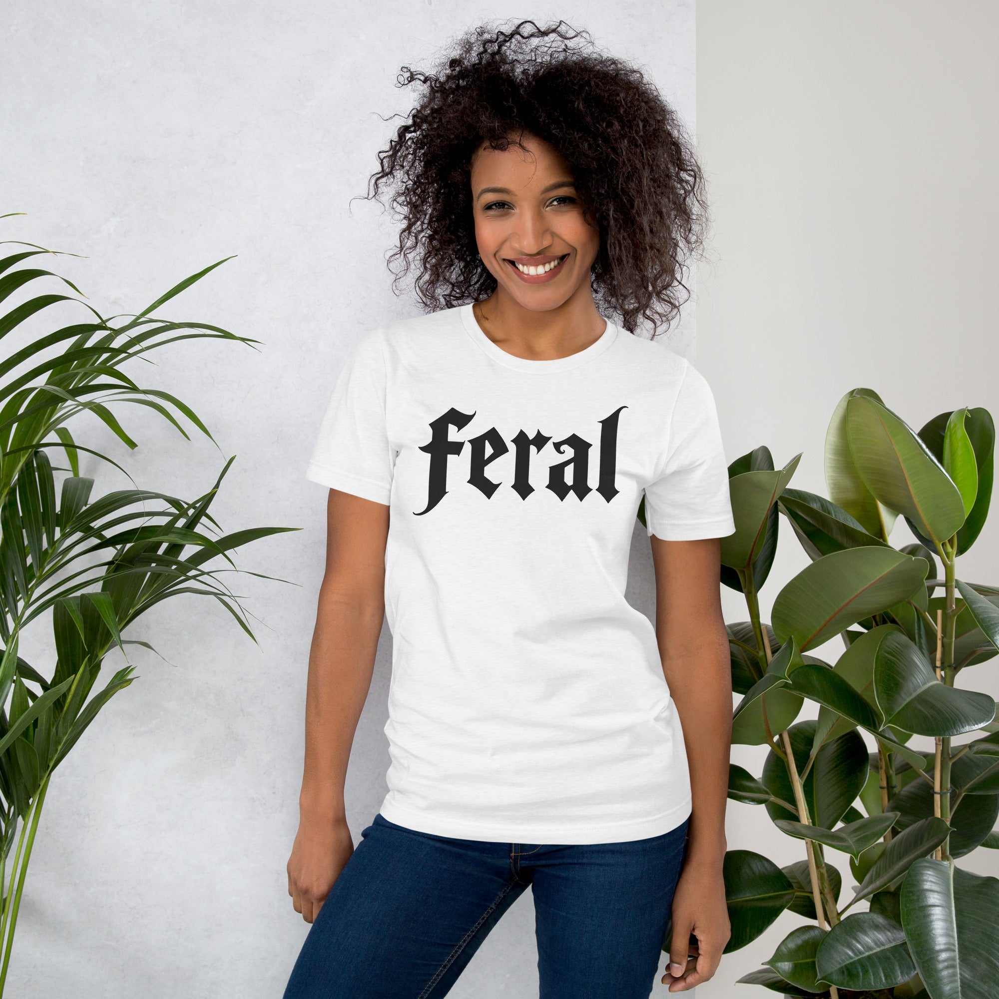 Feral in white blackletter font on dark heather grey t-shirt, bold single word graphic design, Artificial Perdition apparel
