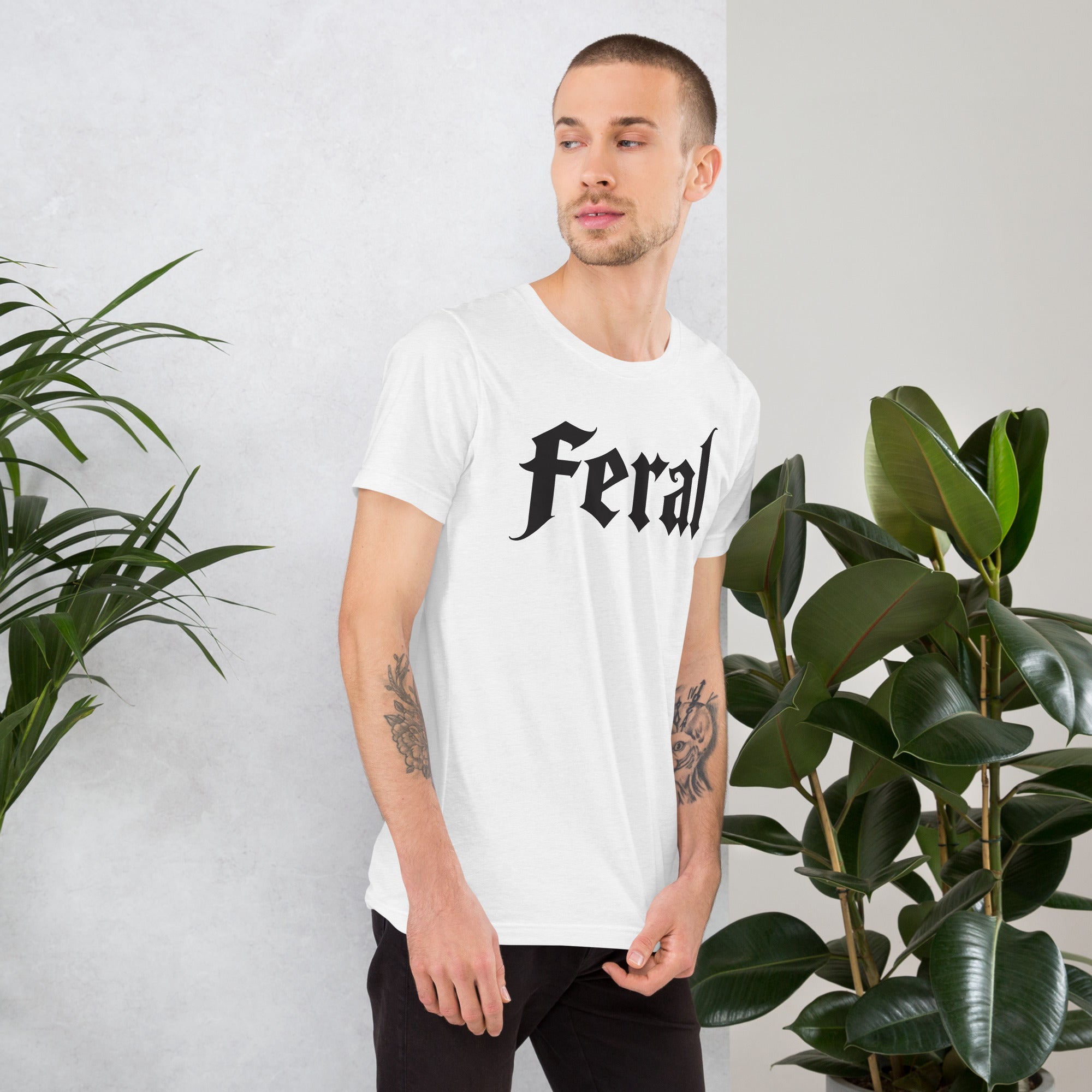 Feral in white blackletter font on dark heather grey t-shirt, bold single word graphic design, Artificial Perdition apparel