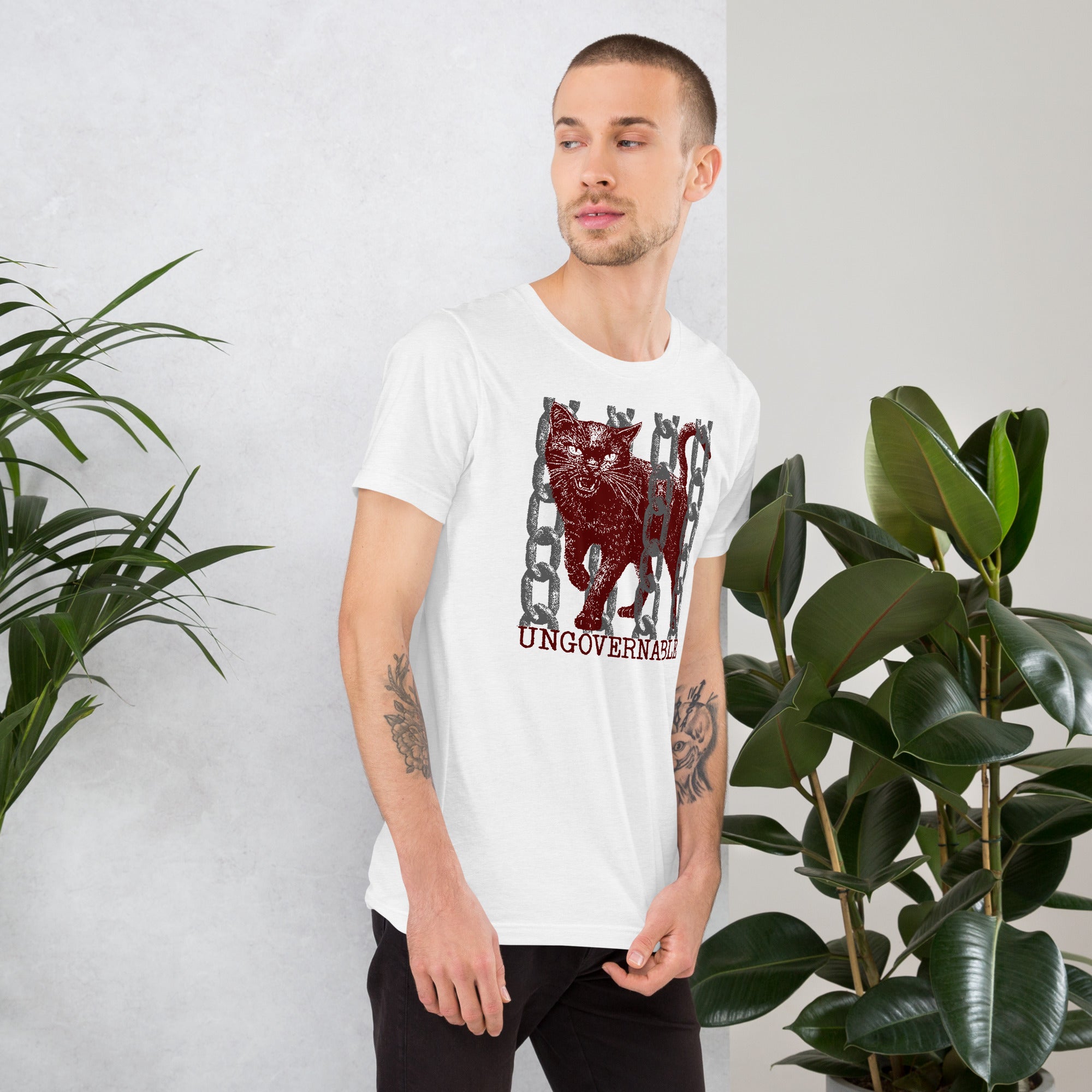 Product mockupSnarling cat breaking through chains with UNGOVERNABLE text, dithered halftone red on cream, Artificial Perdition apparel