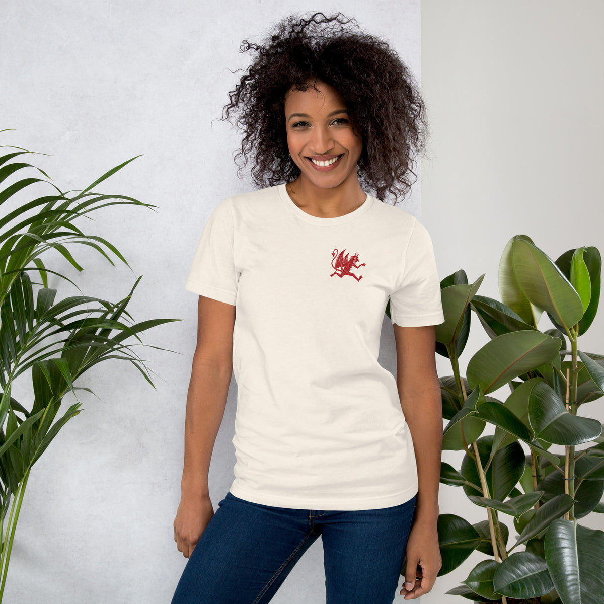 Artificial Perdition devil mascot, red illustrated devil mid-stride with trident and brand name, hand-drawn style on black, official logo tee