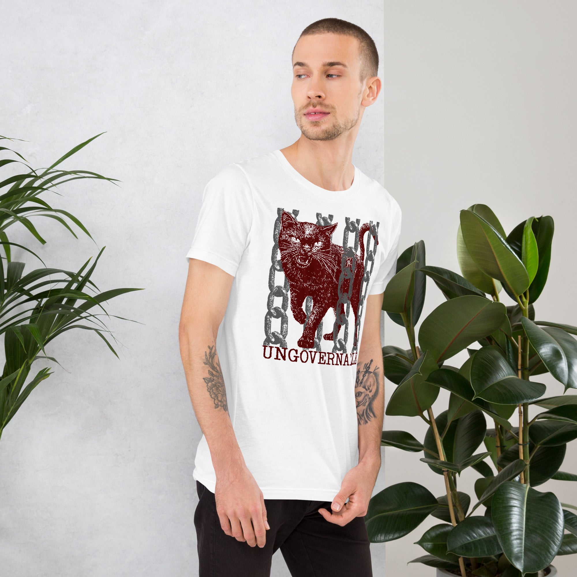 Snarling cat breaking through chains with UNGOVERNABLE text, dithered halftone red on cream, Artificial Perdition apparel