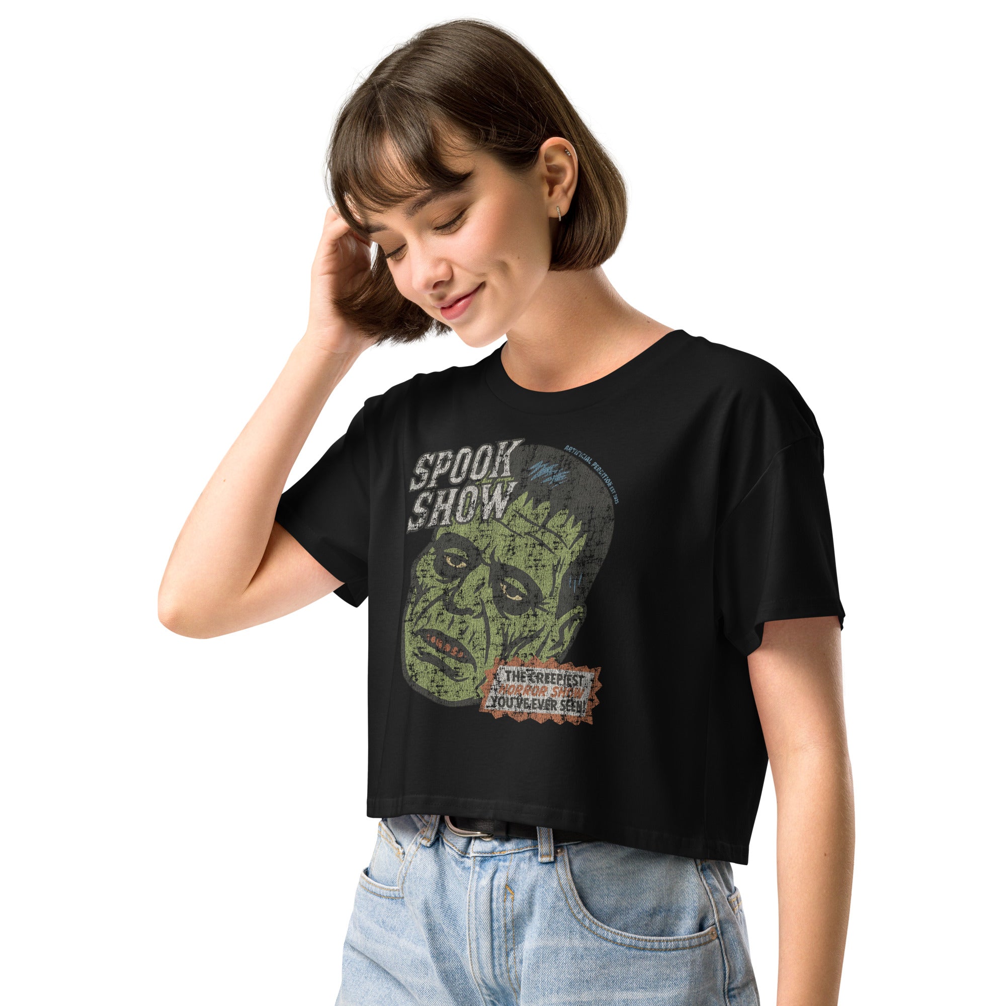A side view of a distressed Frankenstein head with “Spook Show” on premium black crop top.