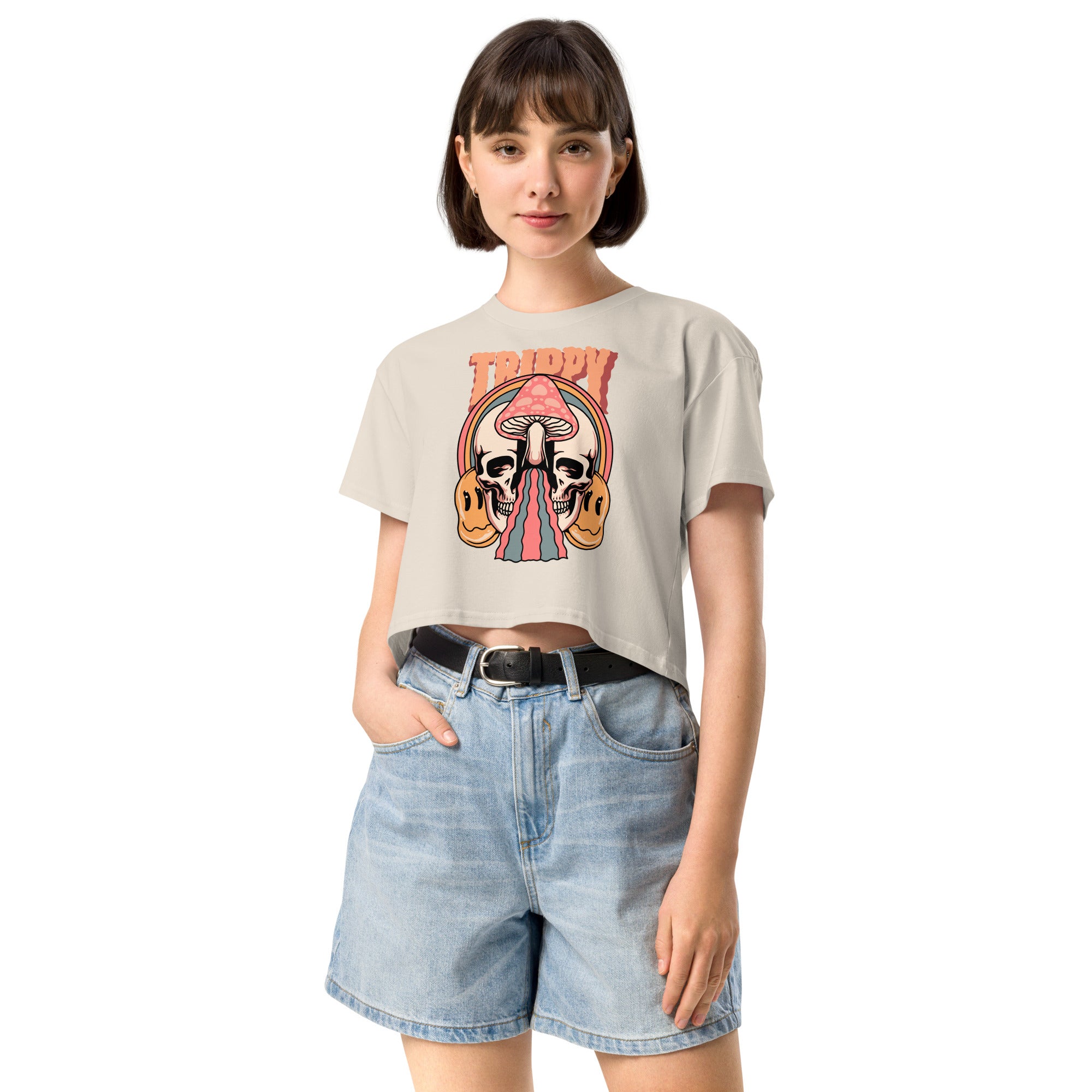 Cropped tee featuring a split skull and mushroom design with melting psychedelic color and smiley faces. Soft combed cotton, eco-friendly inks, playful surreal vibe.