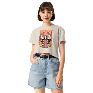 Cropped tee featuring a split skull and mushroom design with melting psychedelic color and smiley faces. Soft combed cotton, eco-friendly inks, playful surreal vibe.