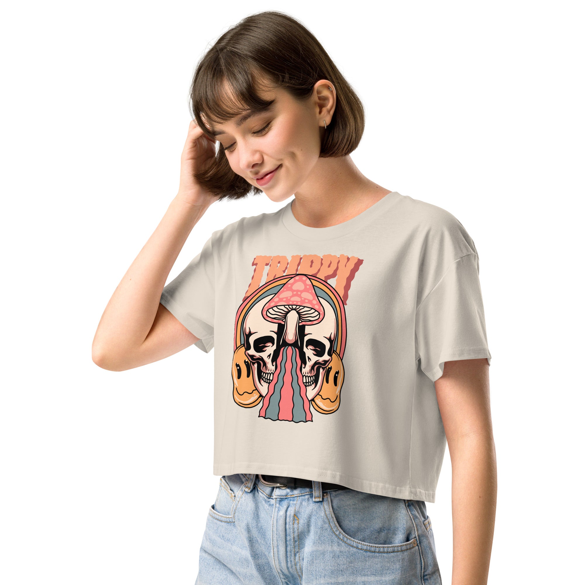 Cropped tee featuring a split skull and mushroom design with melting psychedelic color and smiley faces. Soft combed cotton, eco-friendly inks, playful surreal vibe.
