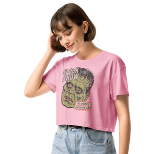 A side view of a distressed Frankenstein head with “Spook Show” on premium bubblegum pink crop top.