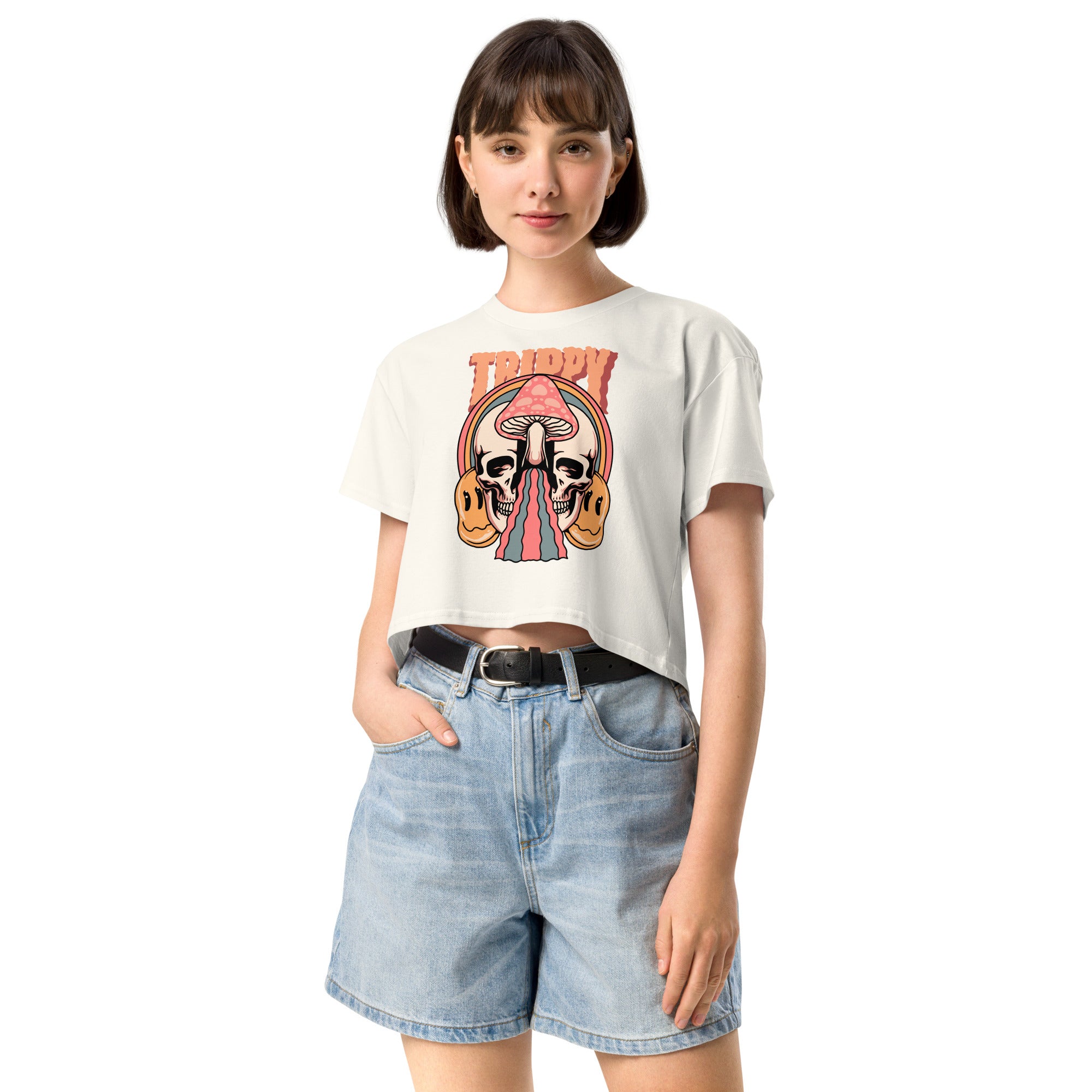 Cropped tee featuring a split skull and mushroom design with melting psychedelic color and smiley faces. Soft combed cotton, eco-friendly inks, playful surreal vibe.