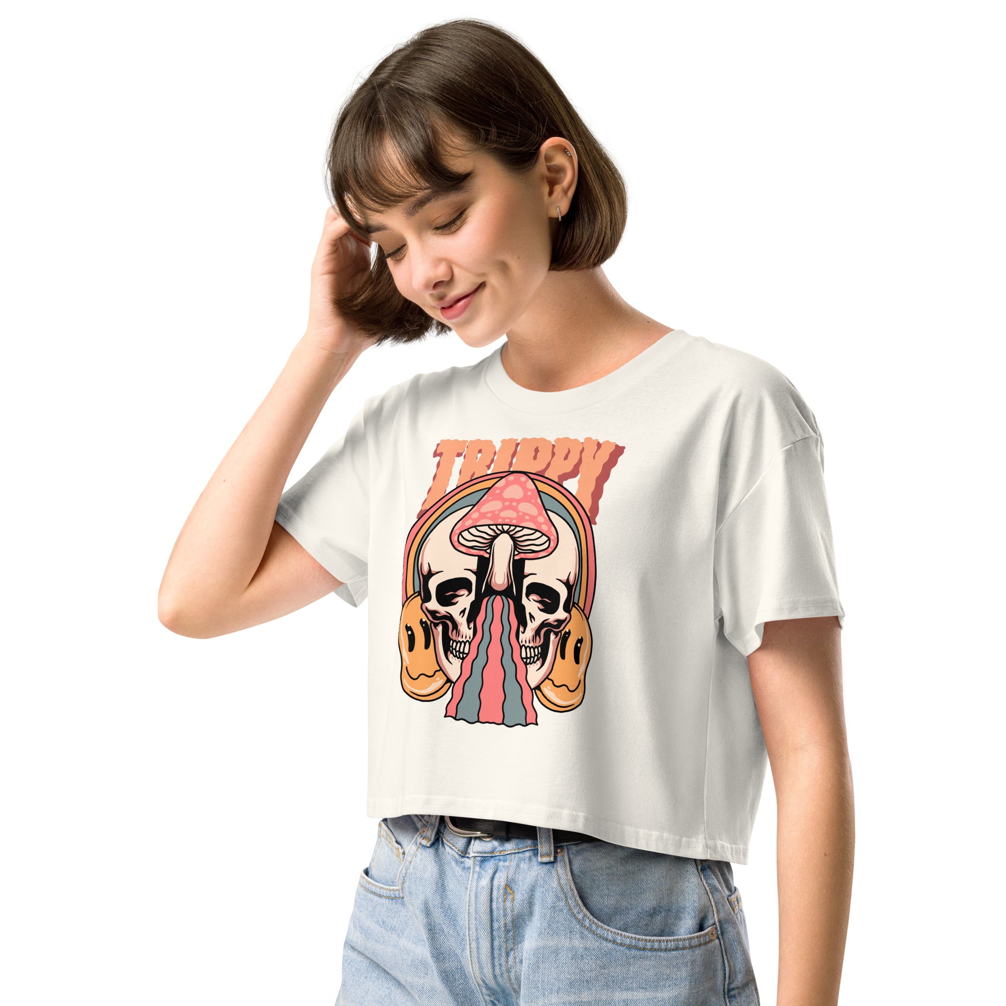 Cropped tee featuring a split skull and mushroom design with melting psychedelic color and smiley faces. Soft combed cotton, eco-friendly inks, playful surreal vibe.