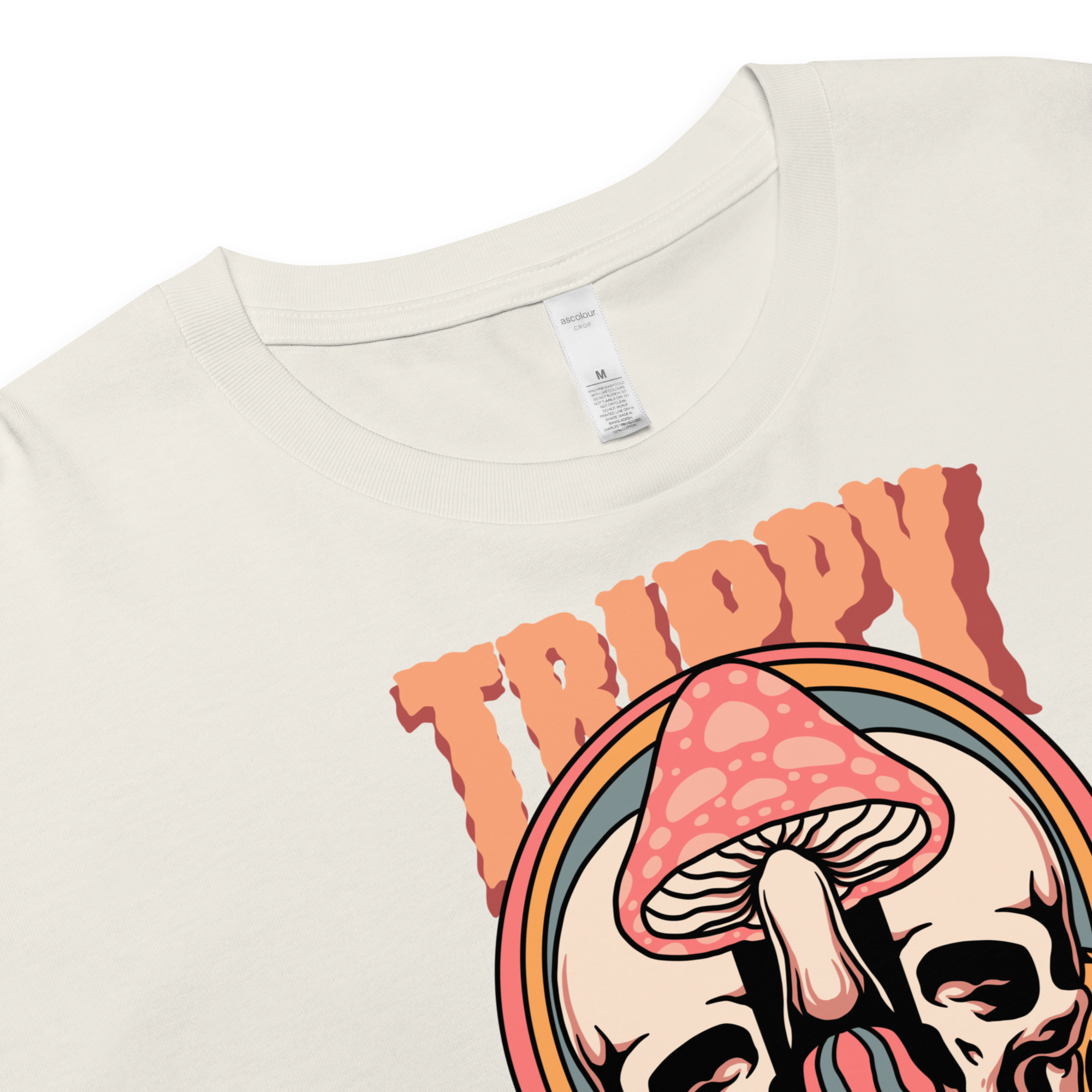Cropped tee featuring a split skull and mushroom design with melting psychedelic color and smiley faces. Soft combed cotton, eco-friendly inks, playful surreal vibe.
