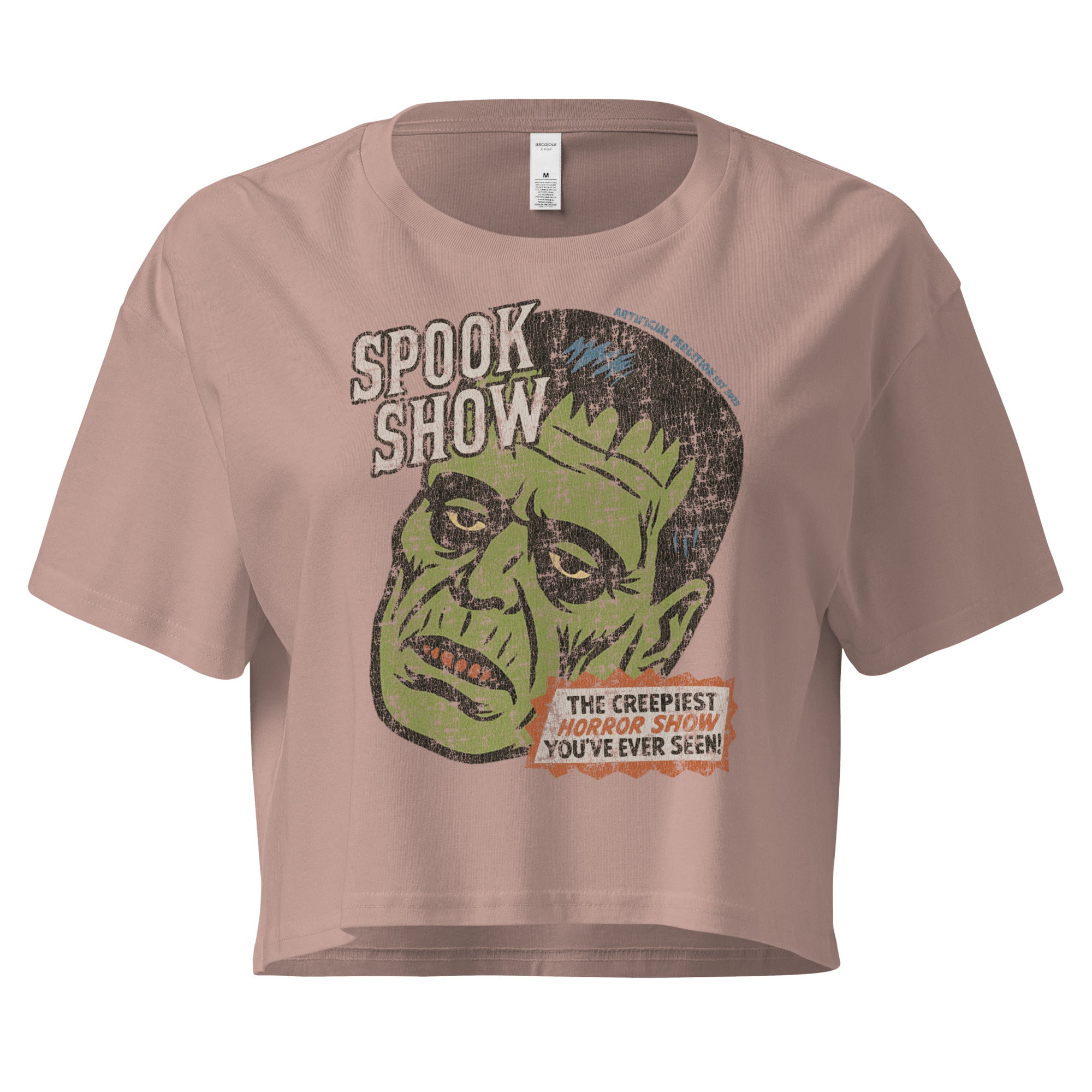 A distressed Frankenstein head with “Spook Show” on premium hazy pink crop top.