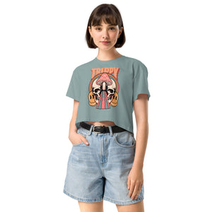Cropped tee featuring a split skull and mushroom design with melting psychedelic color and smiley faces. Soft combed cotton, eco-friendly inks, playful surreal vibe.