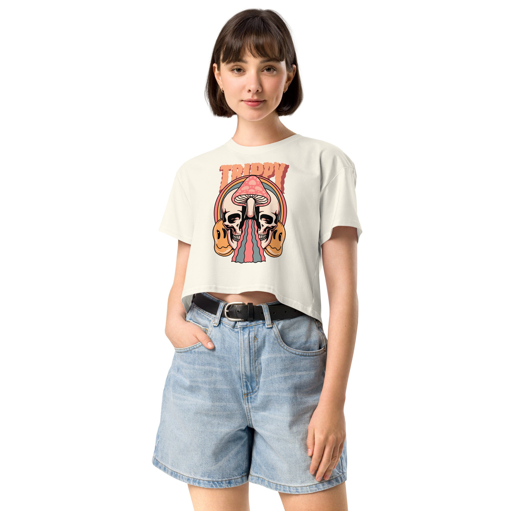 Cropped tee featuring a split skull and mushroom design with melting psychedelic color and smiley faces. Soft combed cotton, eco-friendly inks, playful surreal vibe.