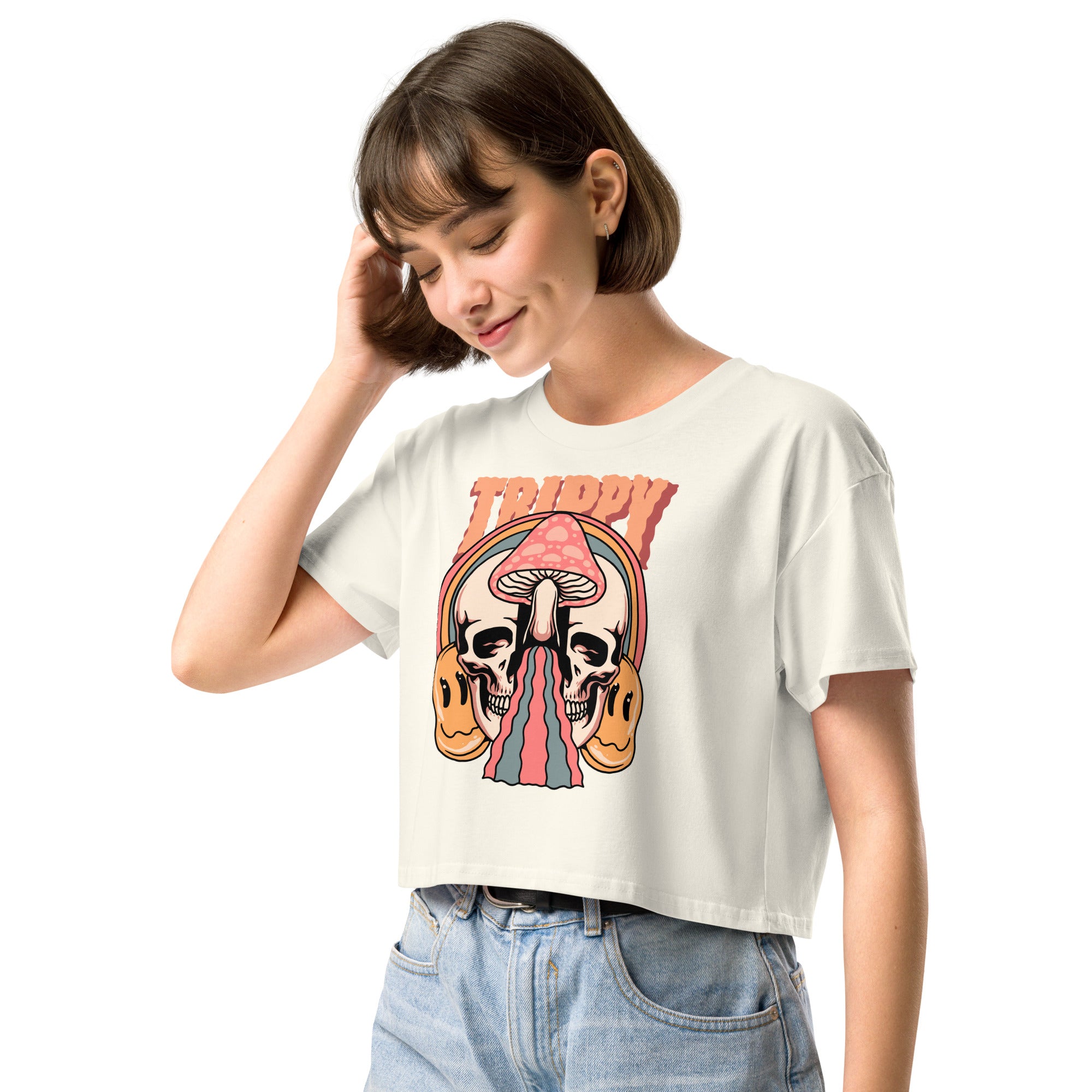 Cropped tee featuring a split skull and mushroom design with melting psychedelic color and smiley faces. Soft combed cotton, eco-friendly inks, playful surreal vibe.