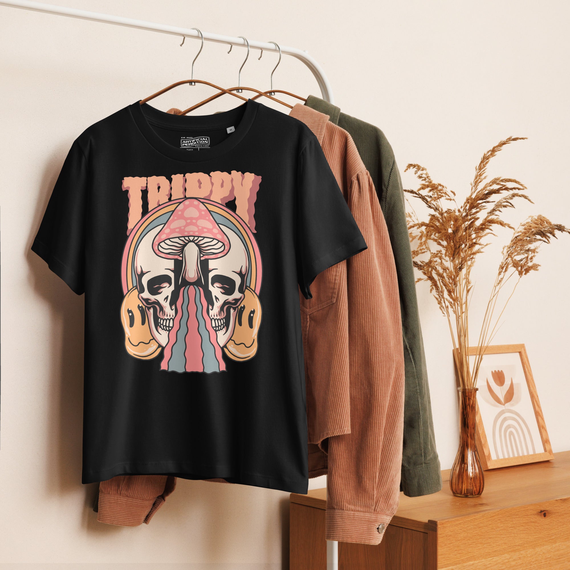 Fitted organic cotton t-shirt with a split skull divided by a pink mushroom, flowing psychedelic shapes, and small smiley faces.