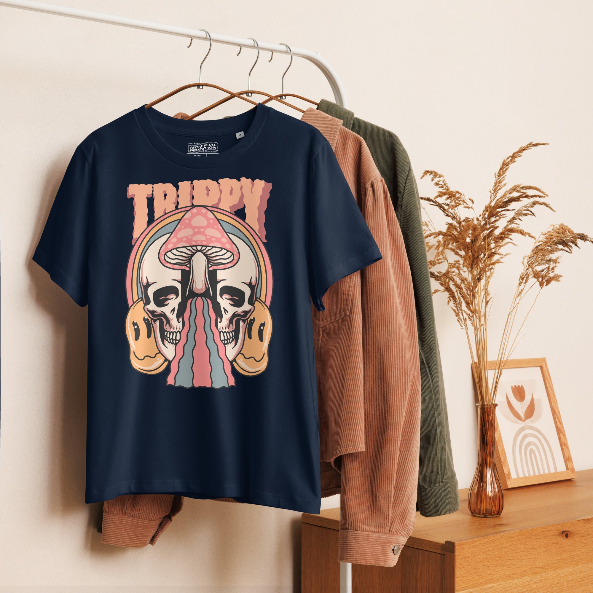 Fitted organic cotton t-shirt with a split skull divided by a pink mushroom, flowing psychedelic shapes, and small smiley faces.