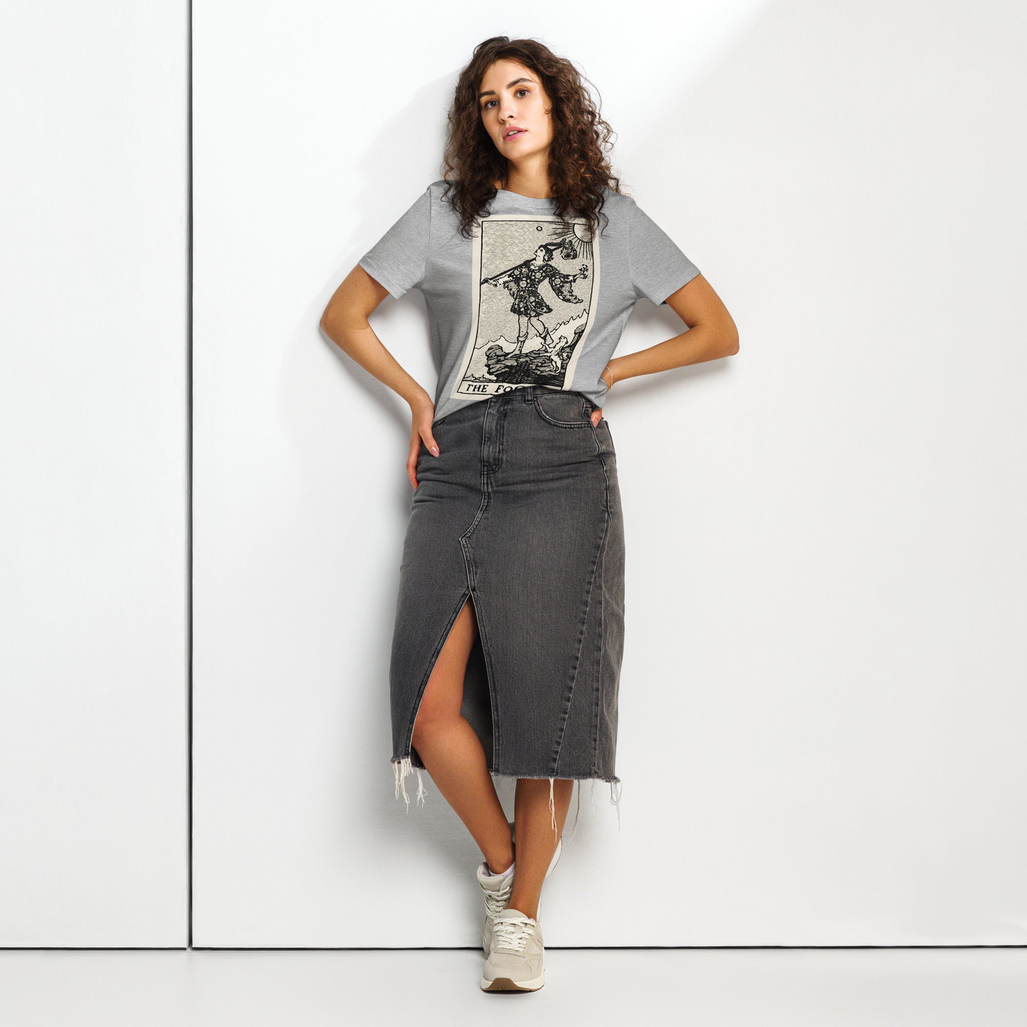 Fitted organic cotton t-shirt featuring The Fool tarot card illustration in high-contrast woodcut rendering.