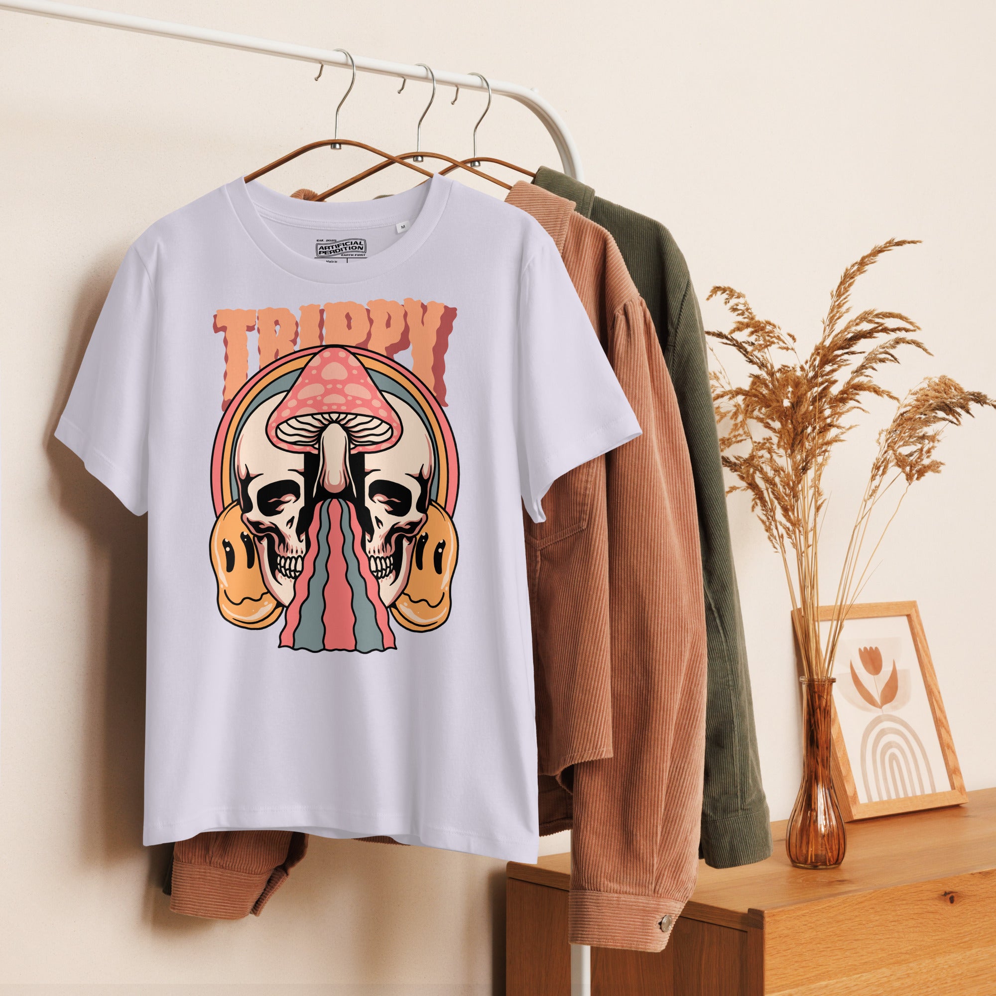 Fitted organic cotton t-shirt with a split skull divided by a pink mushroom, flowing psychedelic shapes, and small smiley faces.