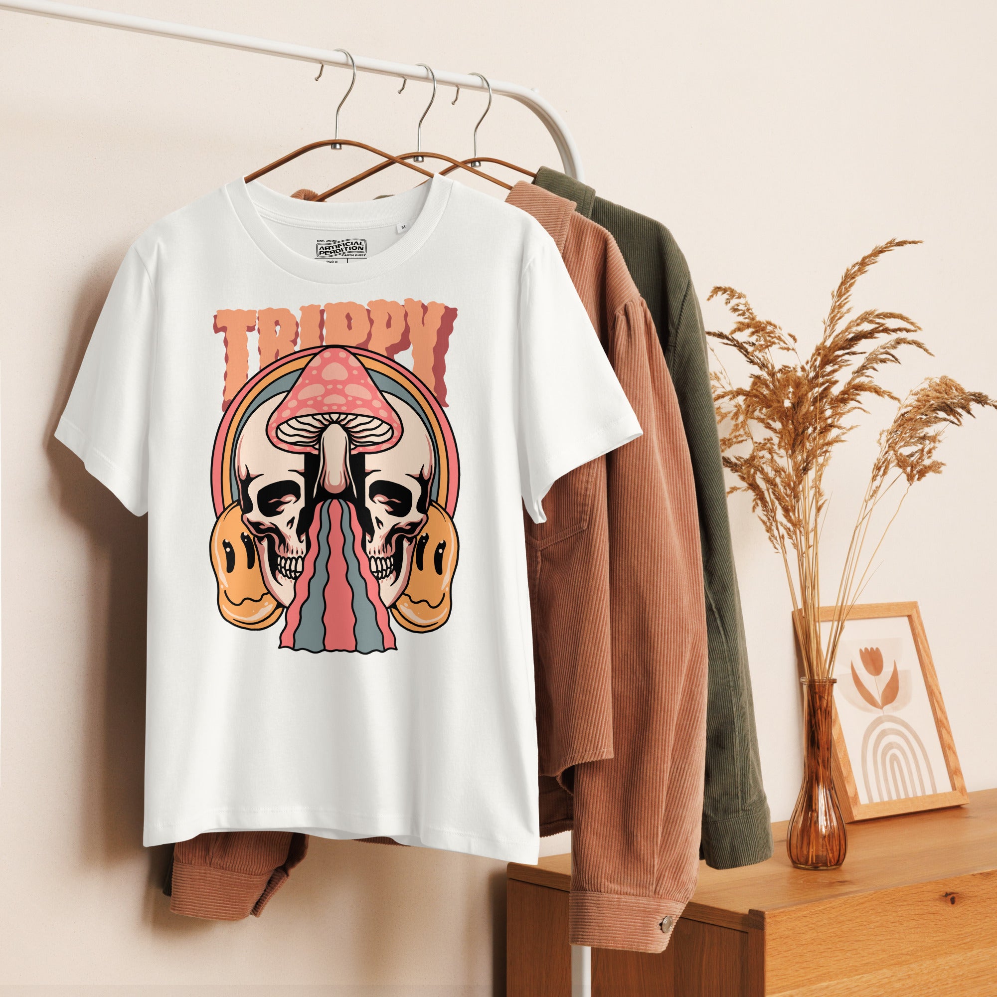 Fitted organic cotton t-shirt with a split skull divided by a pink mushroom, flowing psychedelic shapes, and small smiley faces.